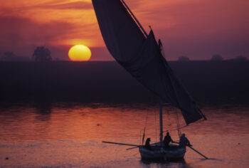 A felucca sails at sunset on the Nile at Luxor, Egypt