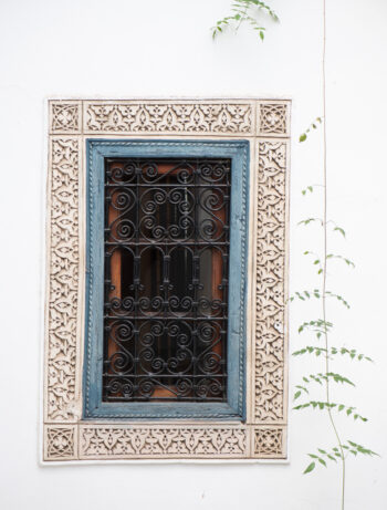 Decorative windows of inside courtyard of a riad in the medina of Marrakesh, Morocco.