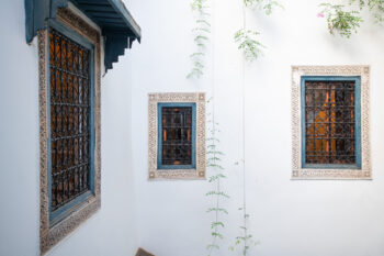 Decorative windows of inside courtyard of a riad in the medina of Marrakesh, Morocco.