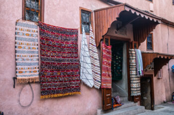 Carpet vendor on street of medina in Marrakesh, Morocco