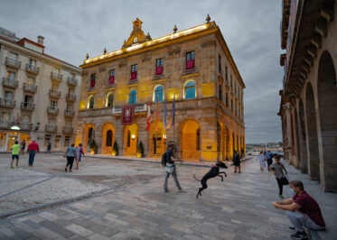 City Hall on Plaza Mayor at night in Guijon, Asturias, Spain