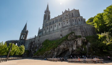 Lourdes is a town in southwestern France, in the foothills of the Pyrenees mountains. It’s known for the Sanctuaires Notre-Dame de Lourdes, or the Domain, a major Catholic pilgrimage site. Each year, millions visit the Grotto of Massabielle (Grotto of the Apparitions) where, in 1858, the Virgin Mary is said to have appeared to a local woman. In the grotto, pilgrims can drink or bathe in water flowing from a spring.