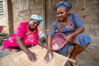Demonstration of making couscous using sorghum by Emefa Ahatefou (blue dress) and Adjo AKANA (pink dress) of Atti-apédokoè. Improving Agricultural Resilience to Salinity through Development and Promotion of Pro-poor Technologies (RESADE). Visit to Togo, 23-25 August 2023. Photos: MIchael Major for ICBA