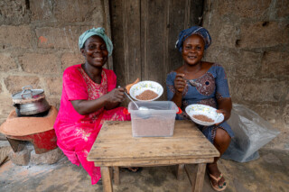 Demonstration of making couscous using sorghum by Emefa Ahatefou (blue dress) and Adjo AKANA (pink dress) of Atti-apédokoè. Improving Agricultural Resilience to Salinity through Development and Promotion of Pro-poor Technologies (RESADE). Visit to Togo, 23-25 August 2023. Photos: MIchael Major for ICBA