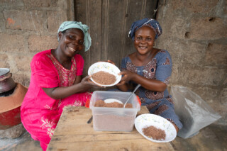 Demonstration of making couscous using sorghum by Emefa Ahatefou (blue dress) and Adjo AKANA (pink dress) of Atti-apédokoè. Improving Agricultural Resilience to Salinity through Development and Promotion of Pro-poor Technologies (RESADE). Visit to Togo, 23-25 August 2023. Photos: MIchael Major for ICBA