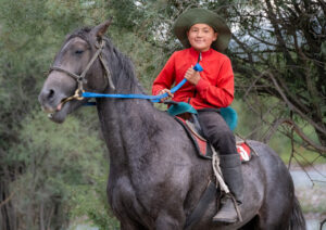 Boy on horseback in northeastern Kyrgyzstan. Crop Trust sponsored visit to Kazakhstan and Kyrgyzstan from 15-28 July to document alfalfa pre-breeding project. Photo: Michael Major for Crop Trust