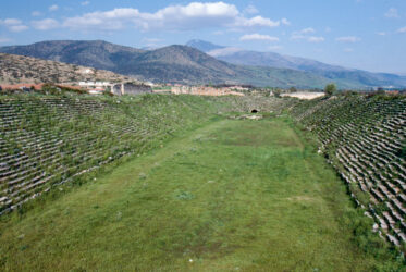 The stadium, 25-tiered, 262m long and 59m wide, seats 30,000, used for jumping, one of best preserved