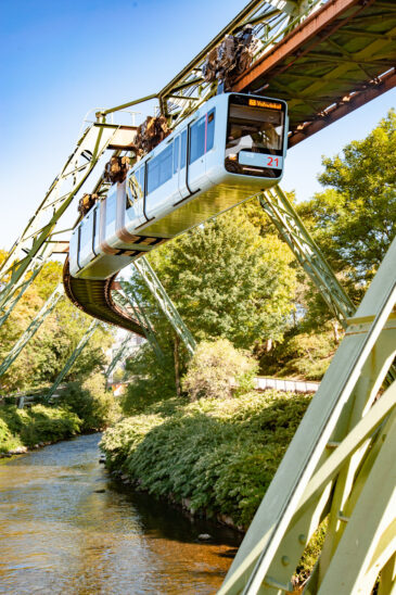 Wuppertal, Nordrhein-Westfalen / Germany - August 21, 2020:  The Wuppertaler Schwebebahn, an electric elevated railway with hanging cars, follows the River Wupper. Designed by Eugen Langen it first opened in 1901.
