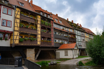 The Krämerbrücke (Merchants' bridge) is a medieval arch bridge in Erfurt, Thuringia in central Germany, which is lined with half timbered shops and houses on both sides of a cobblestone street. It is one of the few remaining bridges in the world that have inhabited buildings. It has been continuously inhabited for over 500 years.