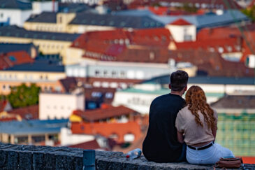 Young couple viewing city from Marienberg Fortress. Würzburg is a German city in the Franconia region of northern Bavaria along the Main River.