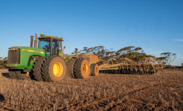 Farmer dry sowing wheat with GPS-guided direct seeder in Kimba, South Australia under dry conditions