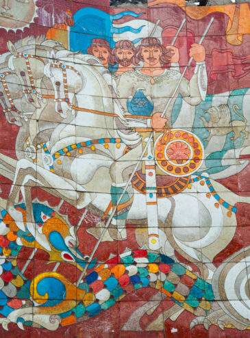 The Treaty of Georgievsk Monument is located along the Georgian Military Highway between the ski resort town of Gudauri and the Jvari Pass in northern Georgia, near the Russian border. This striking circular stone and concrete structure was erected in 1983 to commemorate the bicentennial of the 1783 Treaty of Georgievsk, which established eastern Georgia as a protectorate of the Russian Empire.
Perched on a cliff overlooking the Devil's Valley in the Caucasus Mountains, the monument offers breathtaking panoramic views of the surrounding landscape. Inside, a vibrant tile mural spans the entire circumference, depicting scenes from Georgian and Russian history, including heroes, farmers, fairy tales, and communist symbols