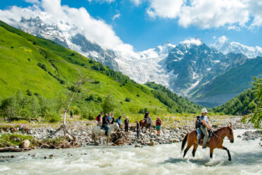 Trekkers crossing the Adishschala River in Georgia's Svaneti region just east of village of Adishi. The crossing is part of the popular Mestia-Ushgali trek.
