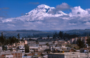 Volcan Chimborazo is Ecuador's highest peak at 6,384,412 m. The summit of Chimborazo is widely reported to be the farthest point from Earth's center as it is only one degree south of the Equator. In the photo it looms over the nearby city of Riobamba.