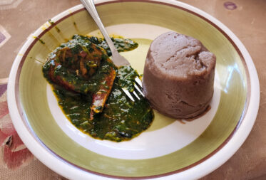 Ninnouwi (jute mallow soup) and telibo (dried yam dough) served in a restaurant in Natitingou, Benin.
Visit by Scott Christiansen and Michael Major, consultants to Crop Trust, to document BOLDER value chain research on fonio and jute mallow in Benin. 11-17 October 2025.
Photo: Michael Major for Crop Trust