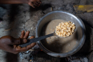 Rose Saimon Kimati, with the help of her two daughters, cooks Bambara groundnut in Unyamikumbi, Singida, Tanzania.
Photo: Michael Major for Crop Trust