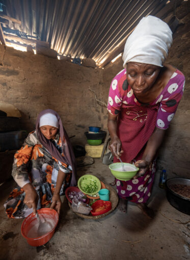 Rose Saimon Kimati, with the help of her two daughters, cooks Bambara groundnut in Unyamikumbi, Singida, Tanzania.
Photo: Michael Major for Crop Trust