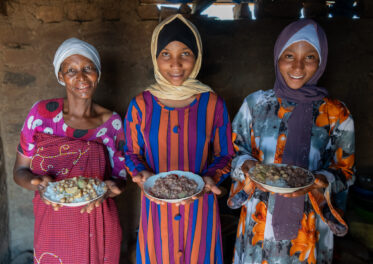 Rose Saimon Kimati, with the help of her two daughters, cooks Bambara groundnut in Unyamikumbi, Singida, Tanzania.
Photo: Michael Major for Crop Trust
