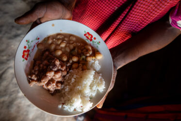 Rose Saimon Kimati, with the help of her two daughters, cooks Bambara groundnut in Unyamikumbi, Singida, Tanzania.
Photo: Michael Major for Crop Trust