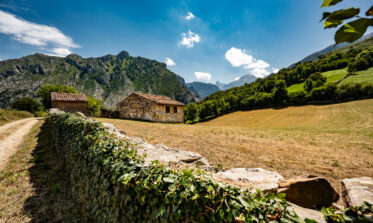 Rural scene showing the Picos de Europa and freshly harvested fields near Las Arenas De Cabrales in Asturias, Spain