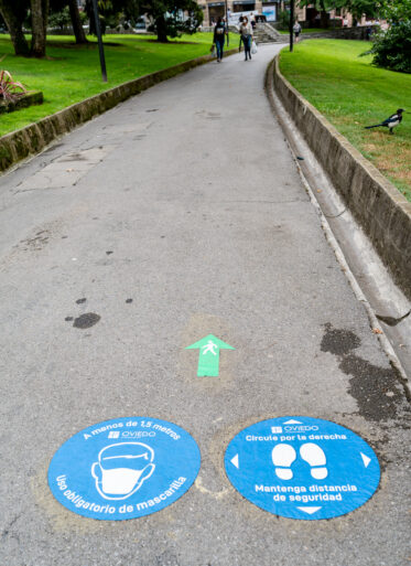 COVID-19 recommendation on footpath in park of Oveido, Asturias, Spain