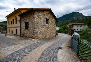 Soto de Agües, Asturias, Spain - August 13 2020: Intricate cobblestone road in village at the trailhead of the Ruta del Alba