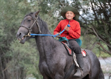 Boy on horseback in northeastern Kyrgyzstan.