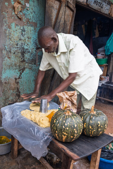 Tom Zijja, a pumpkin processor and aggregator in Balawoli, Kamuli District, Uganda, represents the value-addition end of a growing pumpkin value chain. Sourcing from local farmers, Tom transforms an often-overlooked crop into juice, fritters, flour, puree, and snacks — wasting nothing. Pumpkin is increasingly recognised as a high-potential opportunity crop in Uganda, nutritious, storable, and familiar, but still waiting for the support systems that could take entrepreneurs like Tom from a charcoal stove to something much bigger.
Photo: Michael Major for Crop Trust