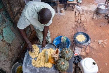 Tom Zijja, a pumpkin processor and aggregator in Balawoli, Kamuli District, Uganda, represents the value-addition end of a growing pumpkin value chain. Sourcing from local farmers, Tom transforms an often-overlooked crop into juice, fritters, flour, puree, and snacks — wasting nothing. Pumpkin is increasingly recognised as a high-potential opportunity crop in Uganda, nutritious, storable, and familiar, but still waiting for the support systems that could take entrepreneurs like Tom from a charcoal stove to something much bigger.
Photo: Michael Major for Crop Trust