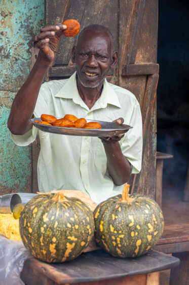 Tom Zijja, a pumpkin processor and aggregator in Balawoli, Kamuli District, Uganda, represents the value-addition end of a growing pumpkin value chain. Sourcing from local farmers, Tom transforms an often-overlooked crop into juice, fritters, flour, puree, and snacks — wasting nothing. Pumpkin is increasingly recognised as a high-potential opportunity crop in Uganda, nutritious, storable, and familiar, but still waiting for the support systems that could take entrepreneurs like Tom from a charcoal stove to something much bigger.
Photo: Michael Major for Crop Trust