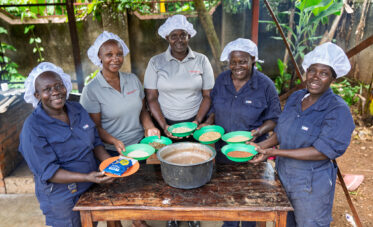 Members of the the ISU-UP/IOWA group present the building blocks of supplementary porridge, a dense protein- and energy-rich food distributed to pregnant and breastfeeding women, young children and households at risk of malnutrition. Grain amaranth, purchased from local farmer groups, is blended with finger millet, maize, soybean and small dried silver fish, then enriched with sugar and milk. One kilogram of the resulting flour, mixed with about six litres of water, yields roughly 15 cups of porridge.
Photo: Michael Major for Crop Trust