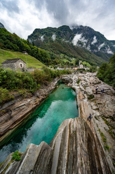 View downstream from the Ponte dei Salti, a 17th century double arch bridge, in the village of Lavertezzo in the Verzasca Valley of the Swiss canton of Ticino.